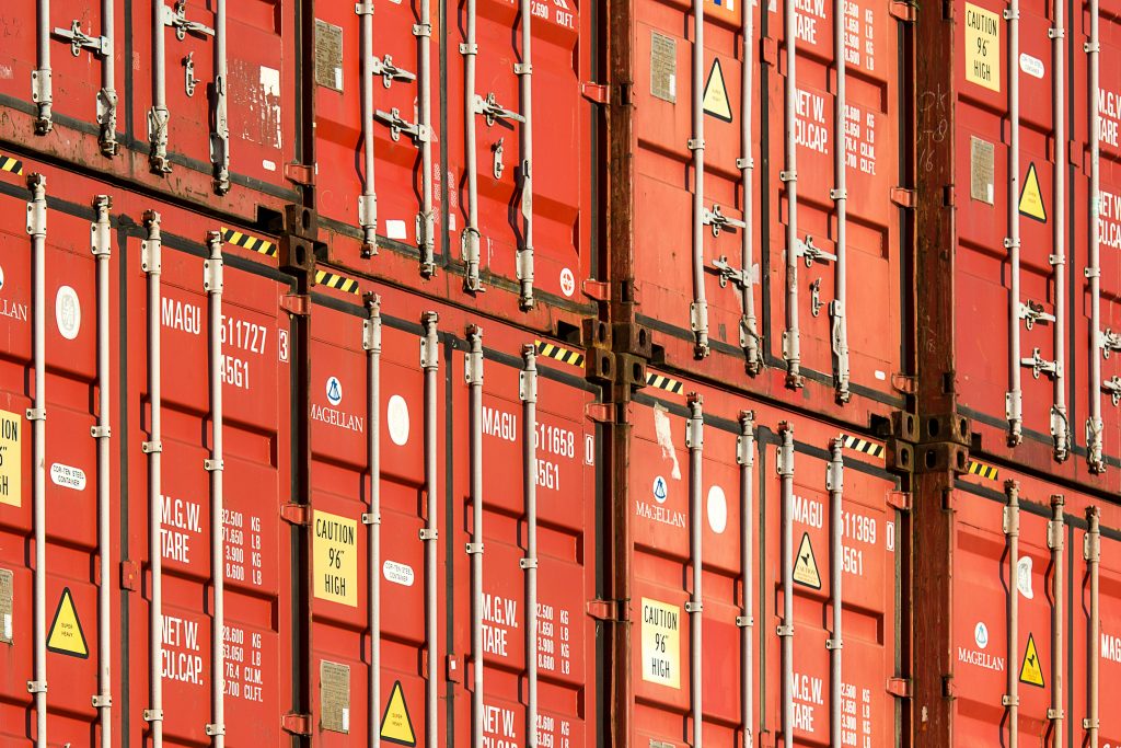 metal-roof Close-up of stacked red shipping containers used for logistics and global trade.